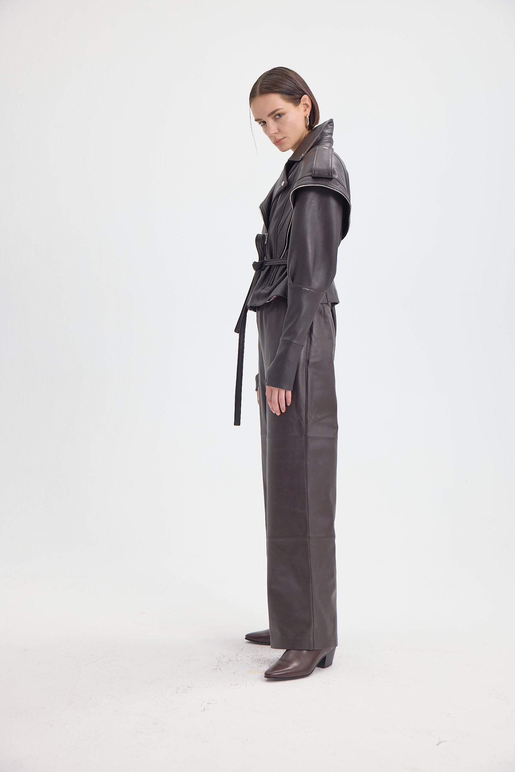 Side view of the DREJANI 'Sogno di Cacao' dark brown leather jacket, highlighting the unique design and high-quality craftsmanship.