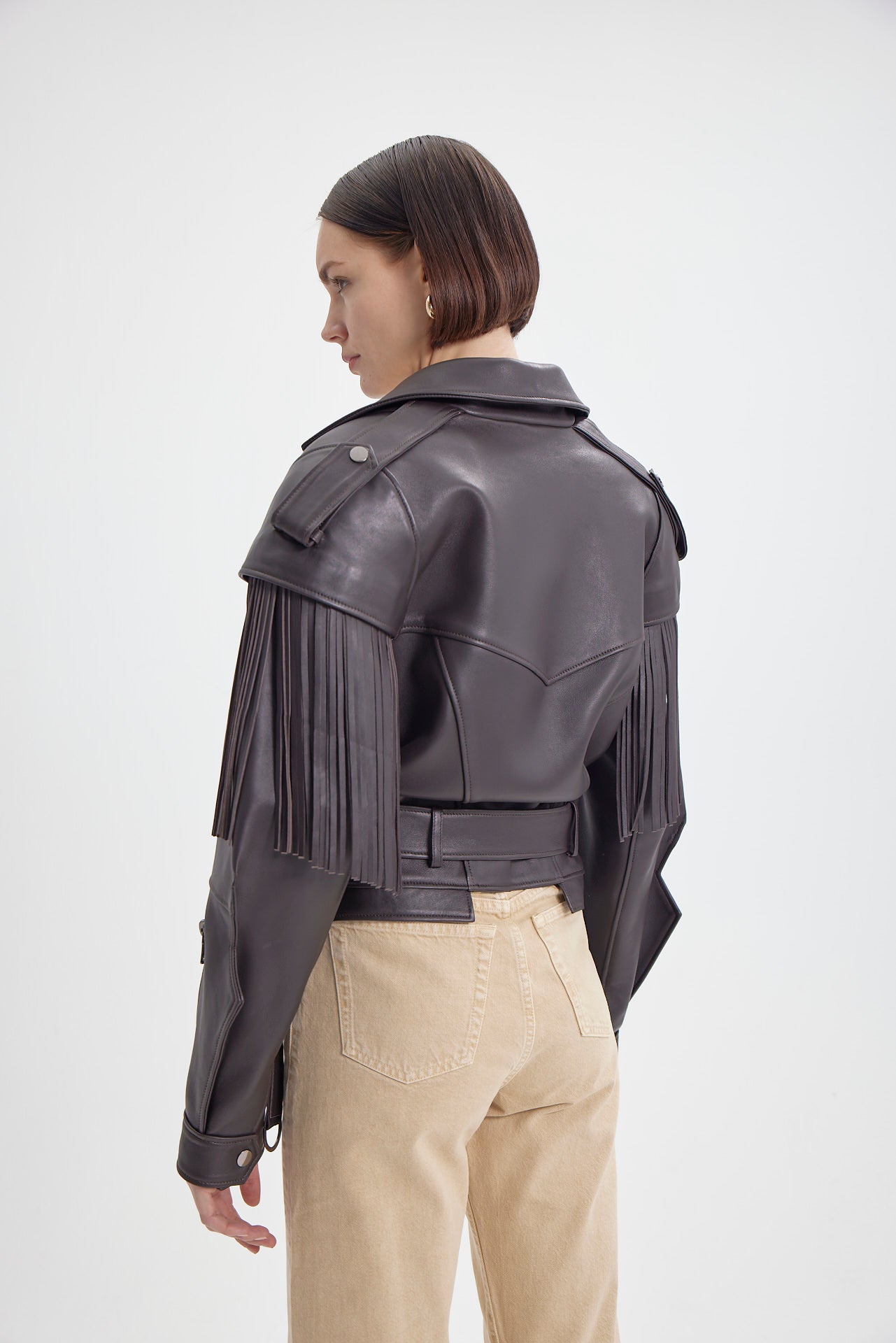 Back view of Brown Fringe Leather Jacket by Drejani, highlighting the fringe details and fitted waist.